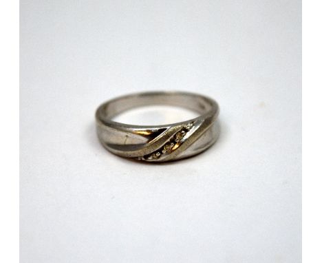 A 9CT GOLD DIAMOND BAND RING, with three single-cut diamonds to a twisted band, hallmarks for Birmingham, ring size V 1/2