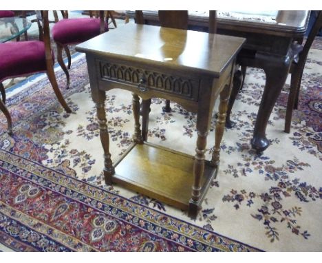 A SMALL CARVED OAK HALL TABLE, with drawer and lower shelf