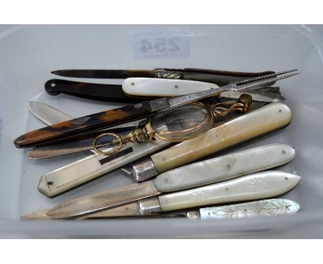 A SMALL COLLECTION OF MOTHER OF PEARL FRUIT KNIVES, together with a fork, a pair of glasses and a penknife (12)