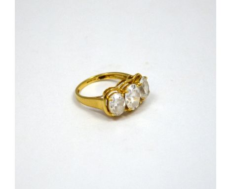 A 9CT GOLD DRESS RING, comprising of three oval shape cubic zirconias to the plain tapered band, hallmarks for Birmingham, ri