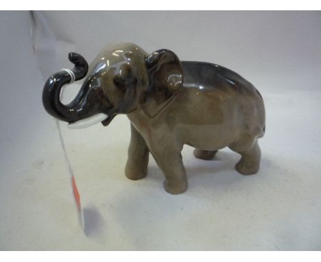 A ROYAL DOULTON ELEPHANT, trunk in salute, style one, HN2644