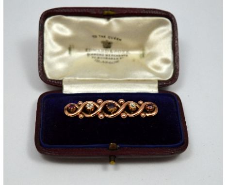 A VICTORIAN ROSE GOLD BAR BROOCH, with ruby and old cut diamonds within the twisted surround, within original fitted box
