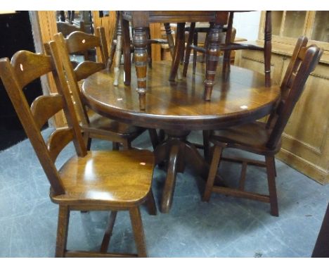 A HEAVY OAK CIRCULAR DINING TABLE, and four ladder back chairs (5)