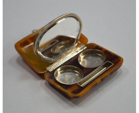 A TORTOISESHELL EFFECT COMPACT/CIGARETTE HOLDER, with fitted interior