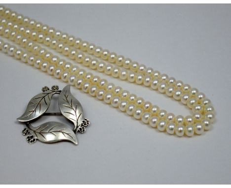 TWO ITEMS OF JEWELLERY, the first a double row pearl necklace together with a silver brooch