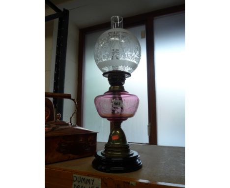 AN OIL LAMP, etched pink glass well and glass shade