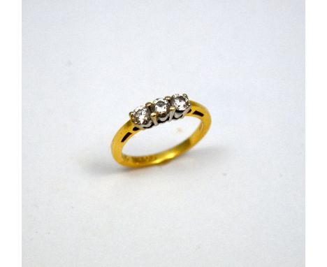 AN 18CT GOLD DIAMOND RING, with three brilliant cut diamonds to the plain band, estimated total diamond weight 0.58ct, F-G co