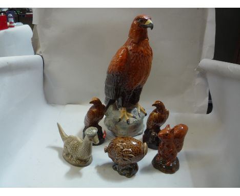 A BESWICK 'GOLDEN EAGLE' WHISKY FLASK, No.2281B, together with five others, 'Loch Ness Monster' No.2051, 'Eagle' No.2104 (x2)