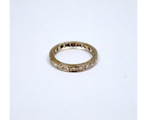 A FULL DIAMOND ETERNITY RING, with single cut diamonds to the fancy scrolling sides, estimated total diamond weight 0.25ct, r