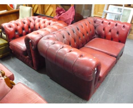 A RED LEATHER TWO SEATER CHESTERFIELD SOFA, and a similar armchair (s.d.) (2)