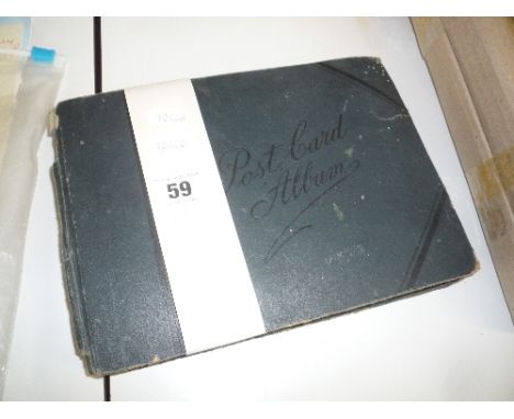 A POSTCARD ALBUM, containing a collection of loosely inserted greetings postcards from the early 20th Century