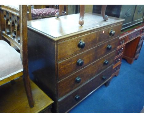 A GEORGIAN OAK CHEST, of two short and three drawers on bracket feet supports