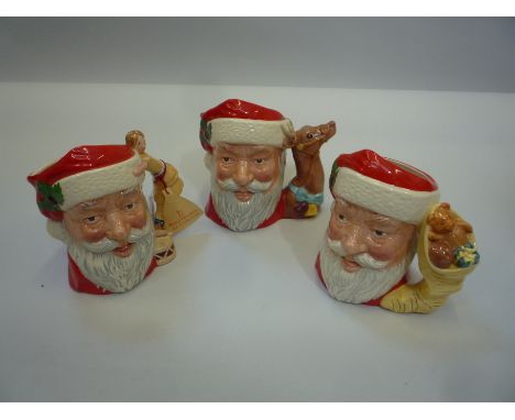 THREE ROYAL DOULTON SANTA CLAUS CHARACTER JUGS, D6668 (doll and drum handle), D6675 (head of Reindeer), D6690 (sack of toys)