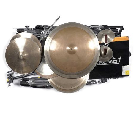 A selection of cymbals and stands, approximately twenty-five cymbals.