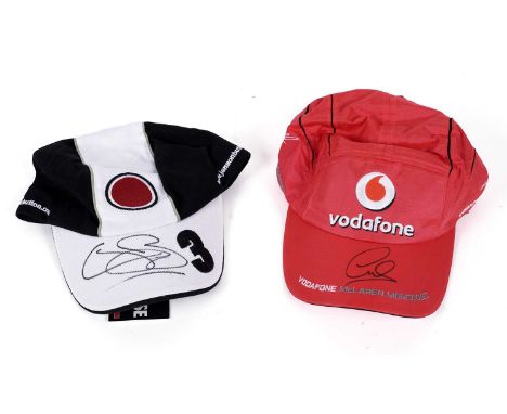 Two autographed caps, Lewis Hamilton and Jenson Button, both with certificates of authenticity. (2)