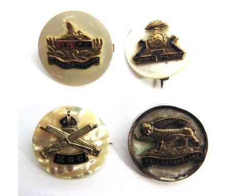 FOUR BRITISH GREAT WAR REGIMENTAL GILT METAL, ENAMEL AND MOTHER OF PEARL SWEETHEART BROOCHES  each of circular form, comprisi