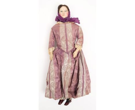 A 19th century shoulder headed doll:, applied brunette wig and painted face on a kid leather body, dress in purple head scarf