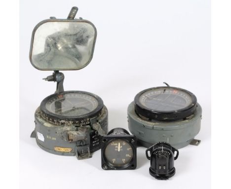 Two aircraft gyro compasses: a flap indicator and a type E2.B compass.


