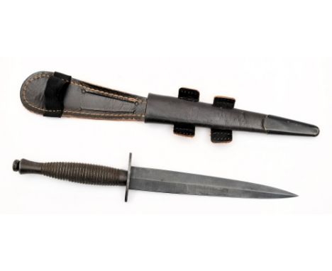 A Fairbairn-Sykes fighting knife:, with blued 17.5cm double edged blade, the cross-guard stamped venture H M Slater, Sheffiel