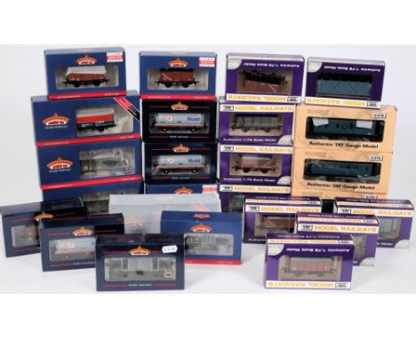 Dapol and Bachmann, a collection of assorted rolling stock: including petrol tankers, ore wagons, brake van etc, all boxed, (