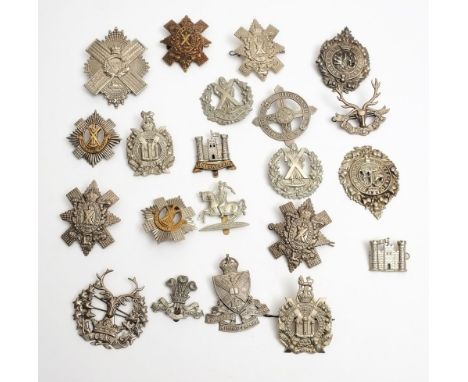A collection of Scottish regiment cap badges and helmet plates:. 