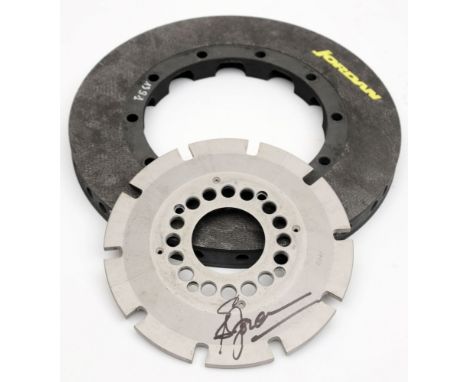 Jordan Formula One Racing Team- a carbon fibre brake disc and aluminium mounting bracket signed by Eddie Jordan:, the carbon 