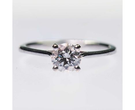A SOLITAIRE DIAMOND RING a round brilliant-cut diamond in a claw setting. Diamond weight 0.70ct, marked '585', ring size L1/2