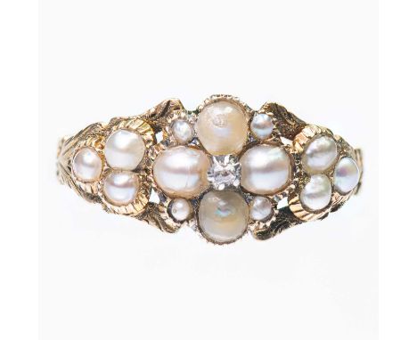 A VICTORIAN SPLIT PEARL CLUSTER RING a cluster of split pearls accented with a diamond, to fancy foliate engraved shoulders a