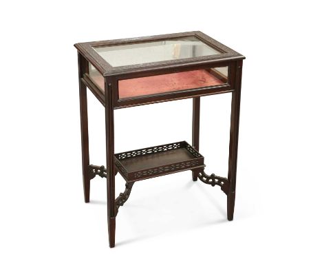 A LATE VICTORIAN MAHOGANY BIJOUTERIE TABLE rectangular, the hinged cover with blind fretwork carving, raised on square-sectio