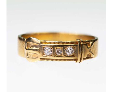 A VICTORIAN DIAMOND GARTER RING three graduated old-cut diamonds inset to a buckle motif band. Marked '18CT', ring size Q, 4.