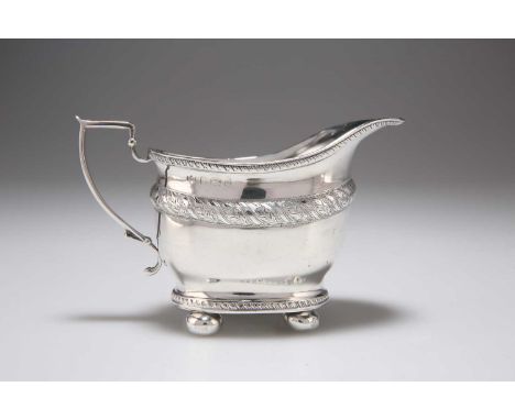 AN EDWARDIAN SILVER CREAM JUG by Marston &amp; Bayliss, Birmingham 1904, deep oval form with gadrooned rims, engraved with a 