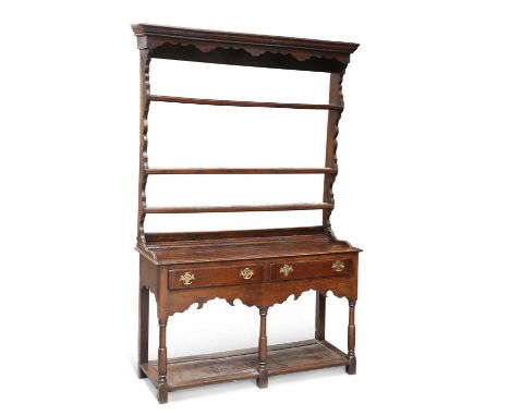 AN 18TH CENTURY OAK DRESSER AND RACK the open rack with three shelves between shaped sides and beneath a shaped apron, the ba