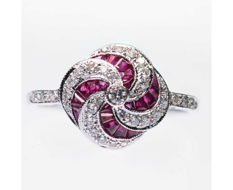 AN 18 CARAT WHITE GOLD RUBY AND DIAMOND CLUSTER RING a round brilliant-cut diamond within a swirling milgrain border of calib