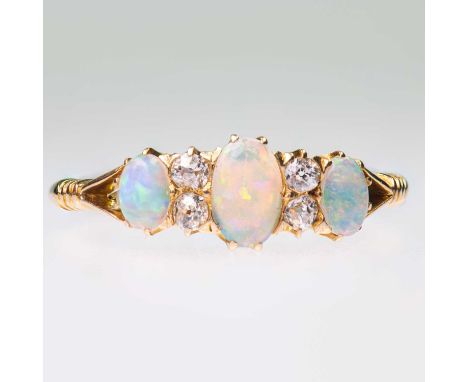 A VICTORIAN OPAL AND DIAMOND RING three graduated oval opals spaced by pairs of old-cut diamonds, to forked shoulders. Estima