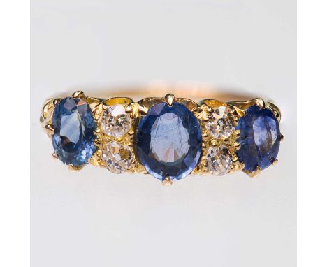 A LATE VICTORIAN 18 CARAT GOLD SAPPHIRE AND DIAMOND RING three cushion-cut sapphires spaced by pairs of old-cut diamonds, to 