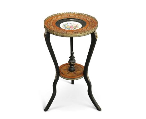 A LATE 19TH CENTURY GILT METAL-MOUNTED, EBONISED AND INLAID GUÉRIDON the circular top inset with a porcelain dished plaque de