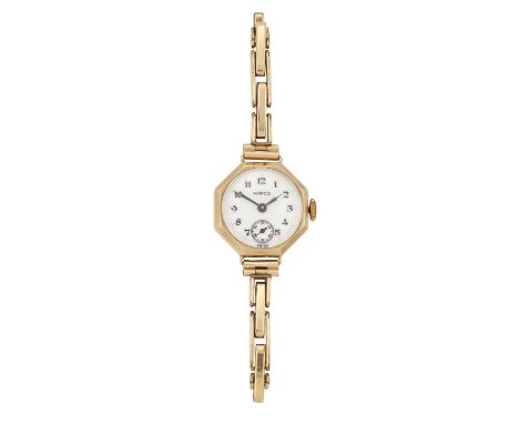 A LADY'S 9 CARAT GOLD HIRCO WATCH ON A ROLLED GOLD BRACLELET the circular white enamel dial signed Hirco with black Arabic in