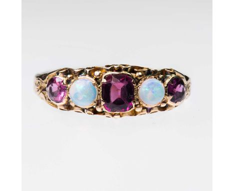 A VICTORIAN 15 CARAT GOLD GARNET AND OPAL RING a cushion-cut garnet spaced by round opals and garnets, to a scroll gallery an