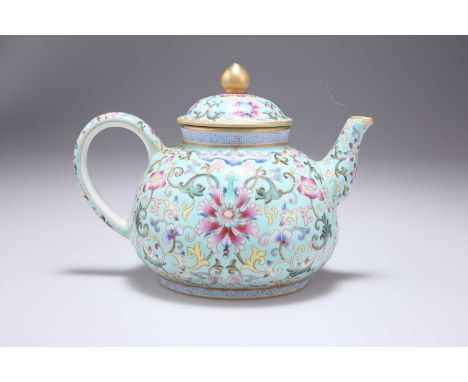 A CHINESE FAMILLE ROSE TEAPOT the turquoise ground profusely enamel painted with scrolling tendrils, lotus and other flowers,