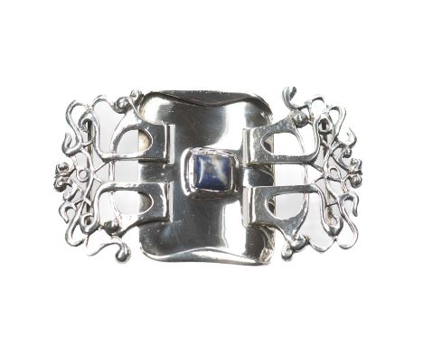 OLIVER BAKER FOR LIBERTY &amp; CO - A SILVER AND LAPIS LAZULI BUCKLE of two-piece construction, a cushion-cut lapis lazuli wi