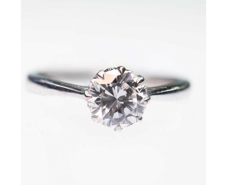 A SOLITAIRE DIAMOND RING a round brilliant-cut diamond in a claw setting, to knife-edge shoulders. Estimated diamond weight 1