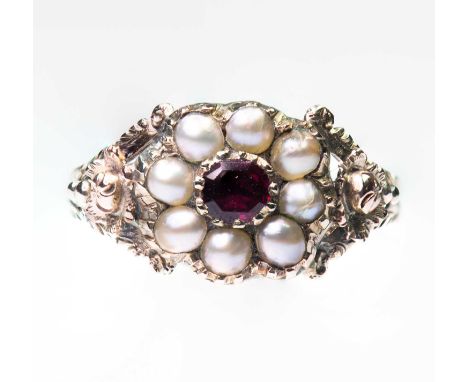 AN EARLY VICTORIAN GARNET AND SPLIT PEARL CLUSTER RING a cushion-cut garnet within a border of split pearls to fancy foliate 