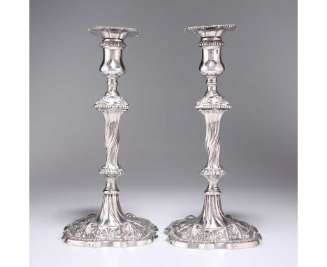 A PAIR OF GEORGE III SILVER CANDLESTICKS by Ebenezer Coker (probably), London 1768, each with a detachable gadrooned rim scon
