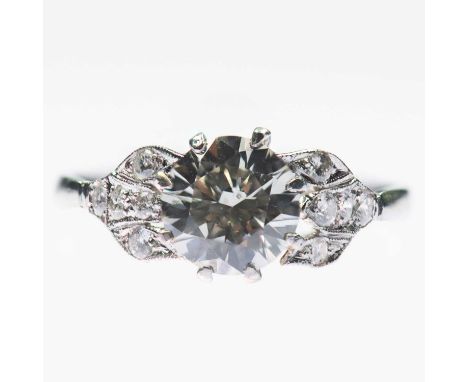 A SOLITAIRE DIAMOND RING a round brilliant-cut diamond to fancy milgrain diamond shoulders. Estimated principal diamond weigh