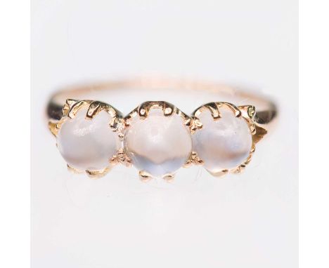 AN EARLY 20TH CENTURY MOONSTONE THREE STONE RING graduated high-domed cabochon moonstones to forked shoulders. Indistinctly m