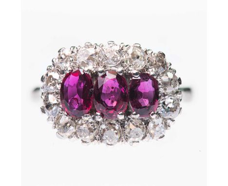 A RUBY AND DIAMOND CLUSTER RING three oval-cut rubies within a border of old-cut diamonds. Estimated total diamond weight 0.8