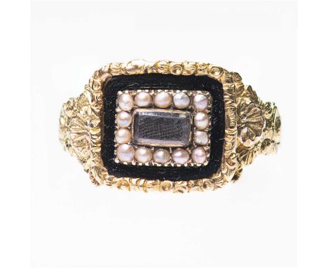 A GEORGIAN 18 CARAT GOLD SEED PEARL AND ENAMEL MOURNING RING a panel of woven hair within a border of seed pearls and black e