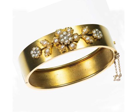 A LATE VICTORIAN DIAMOND AND SPLIT PEARL HINGE OPENING BANGLE a foliate spray set with rose-cut diamonds and split pearls, to