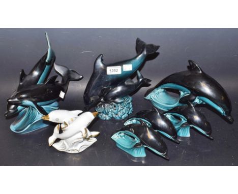 A pod of Poole dolphin models, others similar
