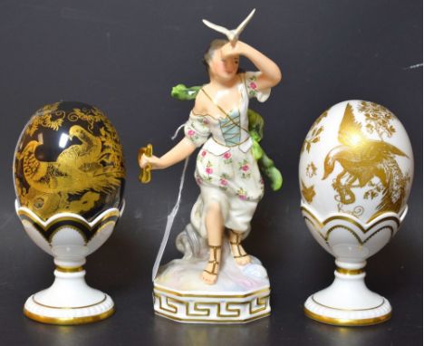 A Royal Crown Derby Black and Gold Avesbury egg on stand, second quality; a White and Gold Avesbury egg on stand, second qual